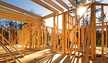Framing a home with sunlight shining in the background